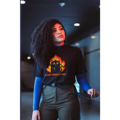 Model wearing Everything Is Fine unisex t-shirt with humorous cat design in a stylish urban setting.