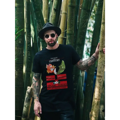 Man wearing 'Battle of the Century' unisex tee featuring Magikarp vs Metapod design amid bamboo backdrop.